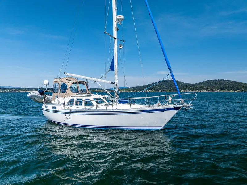 Slide: The Image of Sailing yacht Nauticat 35 Pilot House 2000 on open water under clear blue sky. - 33