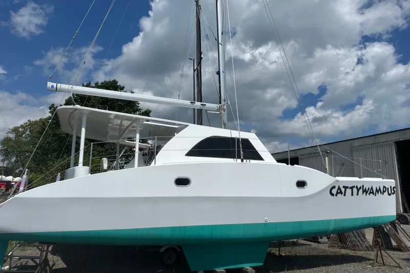 Slide: The Image of Kelsall 38ma catamaran, 2019 model, named "Cattywampus," docked under a cloudy sky. - 13