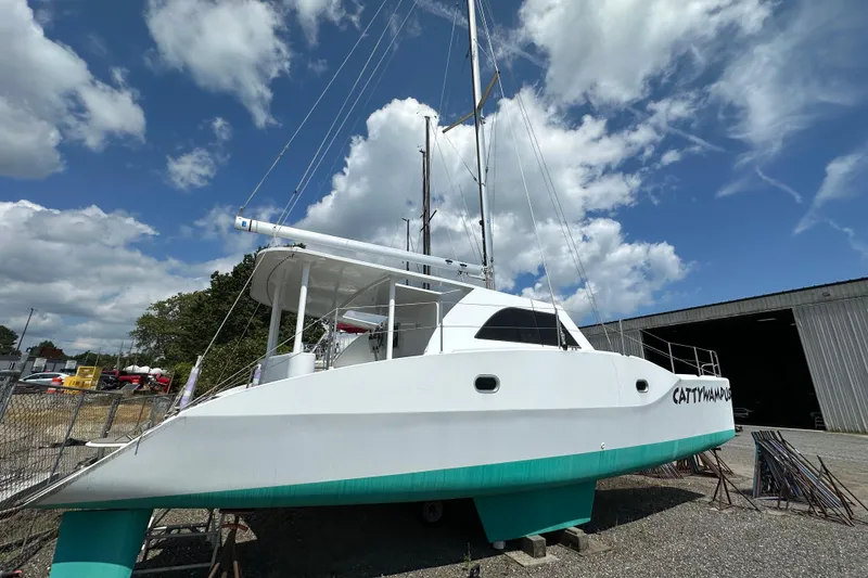 Slide: The Image of Kelsall 38ma catamaran, 2019 model, docked outdoors under a partly cloudy sky. - 14