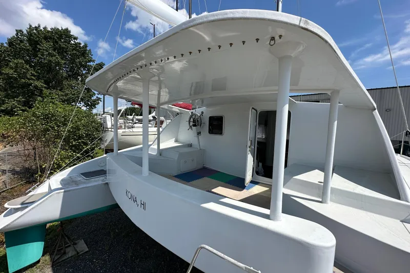 Slide: The Image of 2019 Kelsall 38ma catamaran docked, featuring spacious deck and modern design. - 16