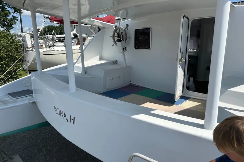 Slide: The Image of Kelsall 38ma catamaran, 2019 model, docked in Kona, HI, with open cabin door. - 17