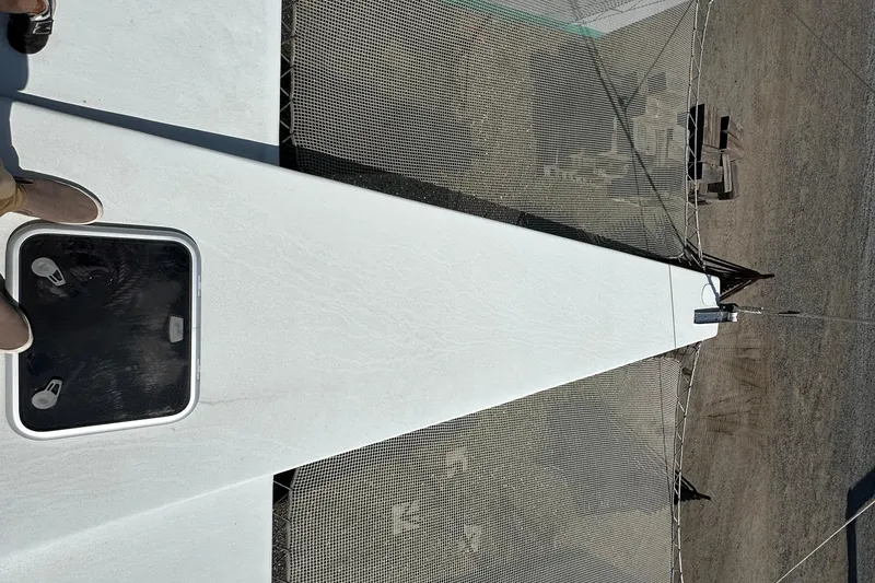 Slide: The Image of Overhead view of a 2019 Kelsall 38ma catamaran deck with netting and hatch. - 20