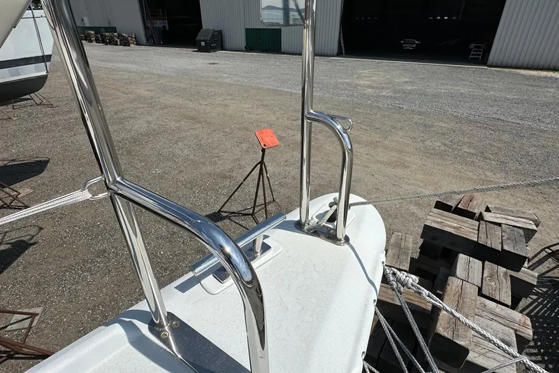 Slide: The Image of Kelsall 38ma sailboat deck with stainless steel railings, 2019 model, in a boatyard setting. - 21