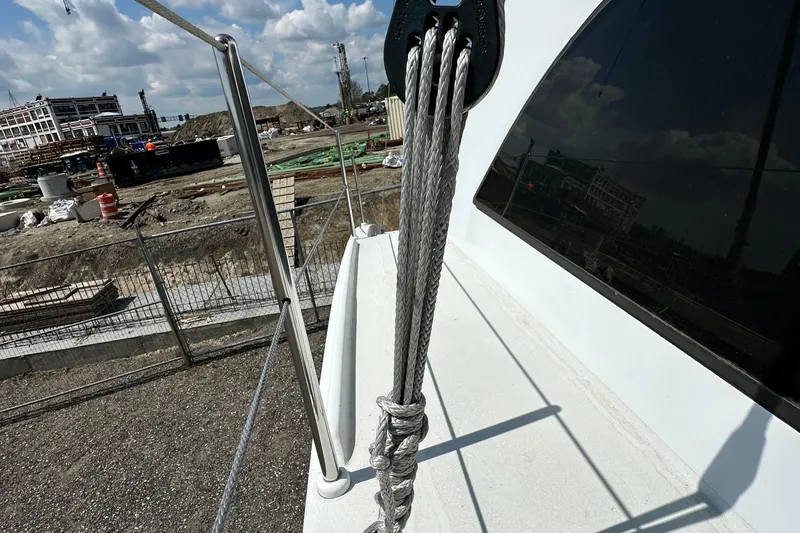 Slide: The Image of Rope rigging on a 2019 Kelsall 38ma catamaran, with construction site in the background. - 23