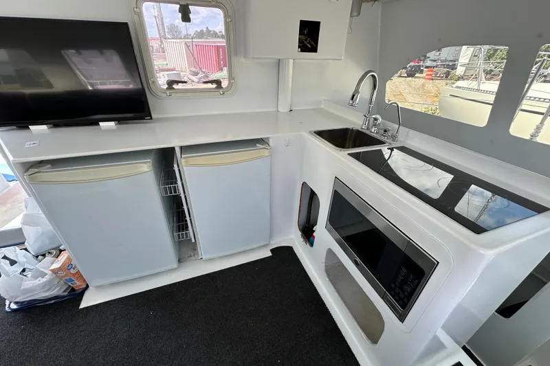 Slide: The Image of Modern kitchen area in a 2019 Kelsall 38ma boat with appliances and dual fridges. - 35