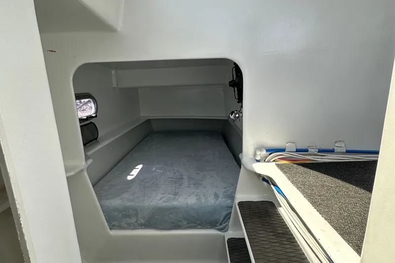 Slide: The Image of Interior cabin of 2019 Kelsall 38ma catamaran, featuring a compact sleeping area. - 38