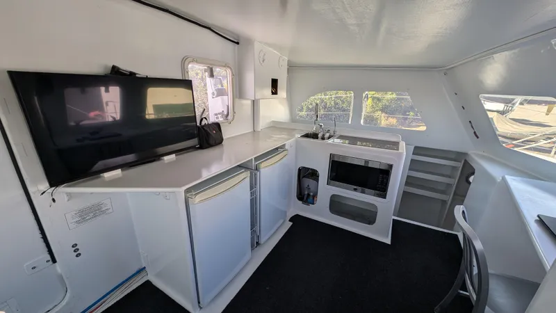 Slide: The Image of Modern interior of 2019 Kelsall 38ma catamaran with kitchen and TV. - 4