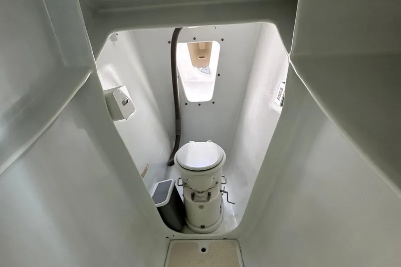 Slide: The Image of Interior of a 2019 Kelsall 38ma boat bathroom with toilet and window. - 40