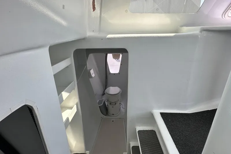 Slide: The Image of Interior of 2019 Kelsall 38ma boat showing compact bathroom area with toilet. - 41
