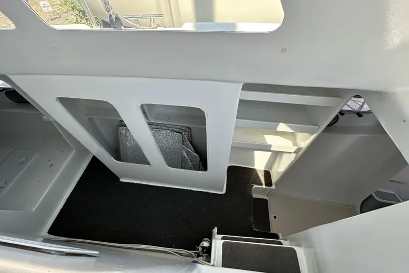Slide: The Image of Interior of 2019 Kelsall 38ma boat with shelves and carpeted floor. - 43
