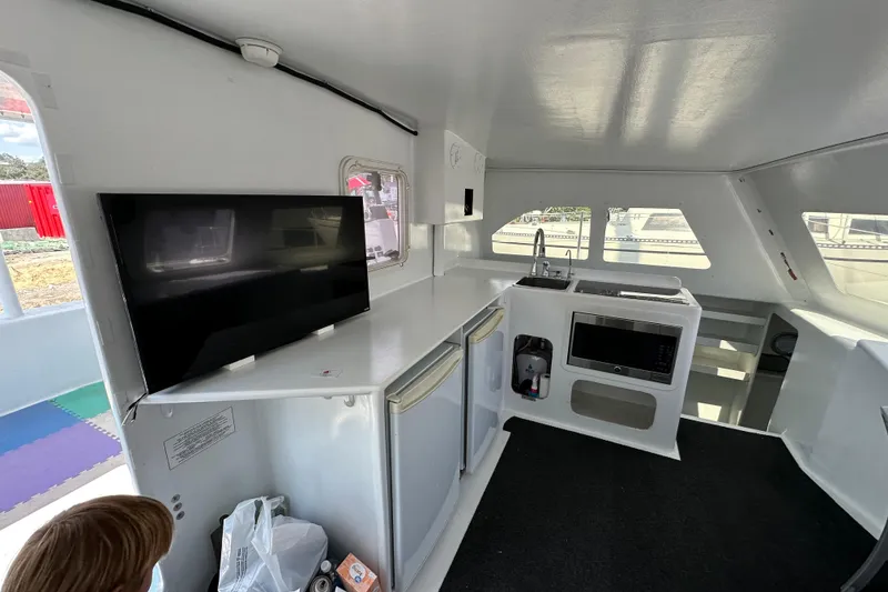 Slide: The Image of Interior of 2019 Kelsall 38ma catamaran with modern kitchen and TV setup. - 48