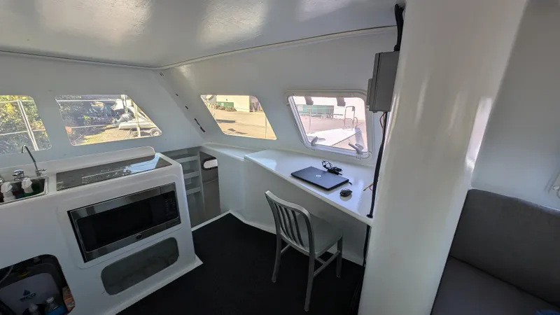 Slide: The Image of Modern interior of 2019 Kelsall 38ma catamaran with desk and kitchenette. - 5