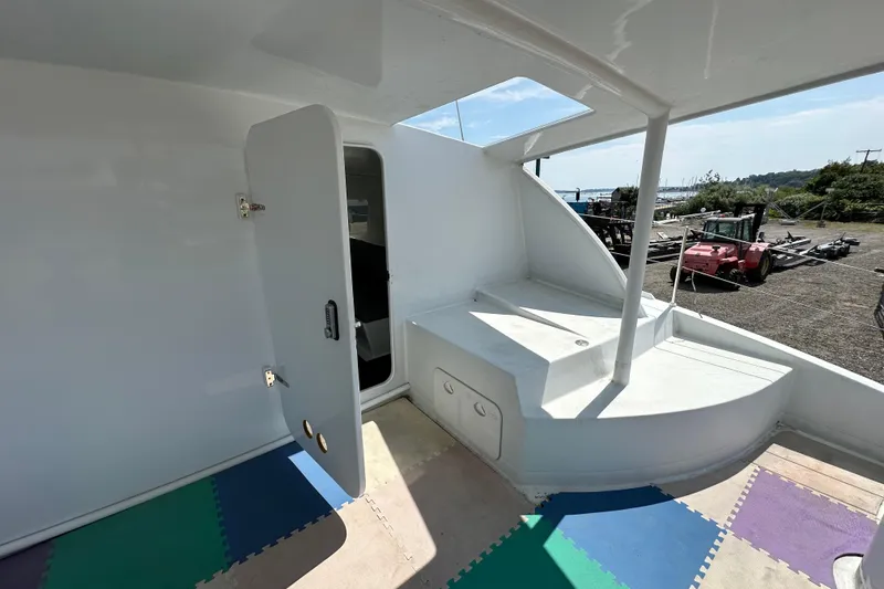 Slide: The Image of Interior view of 2019 Kelsall 38ma catamaran with open door and colorful flooring. - 51
