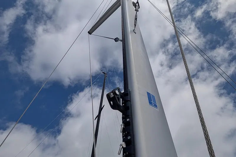 Slide: The Image of Sailboat mast of 2019 Kelsall 38ma against a cloudy blue sky. - 56
