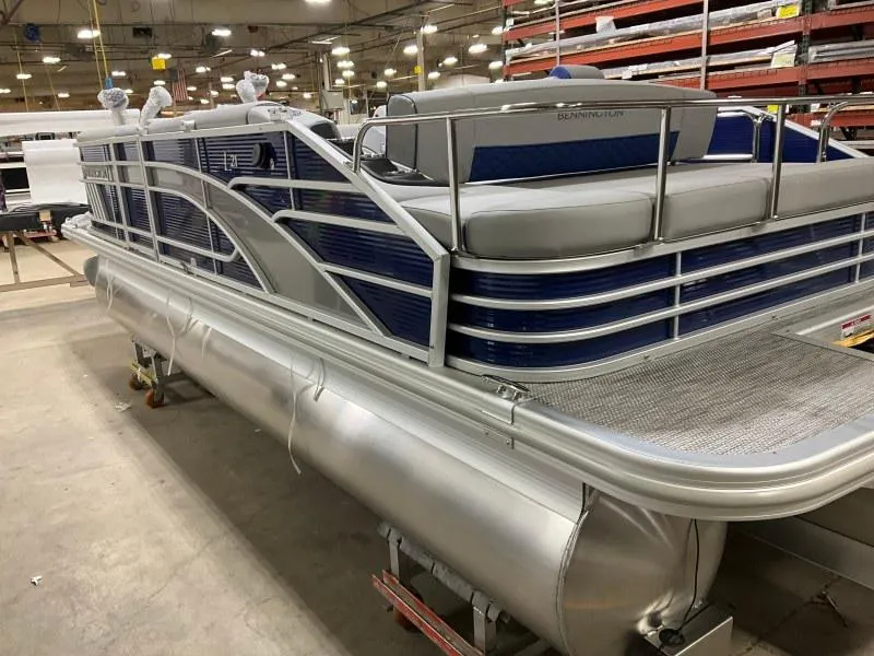The Image of 2023 Bennington 21LSB pontoon boat on trailer, parked outdoors. - 0