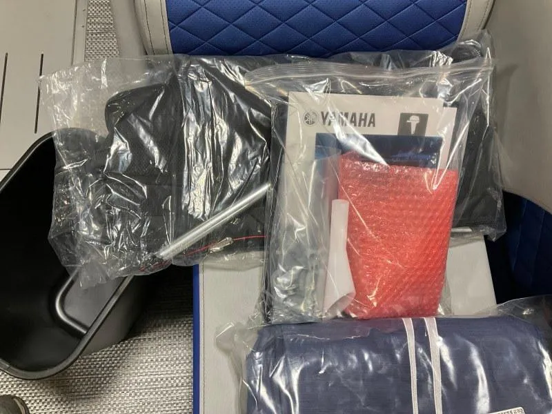 Slide: The Image of 2023 Bennington 21LSB pontoon boat with blue canopy docked at marina. - 10