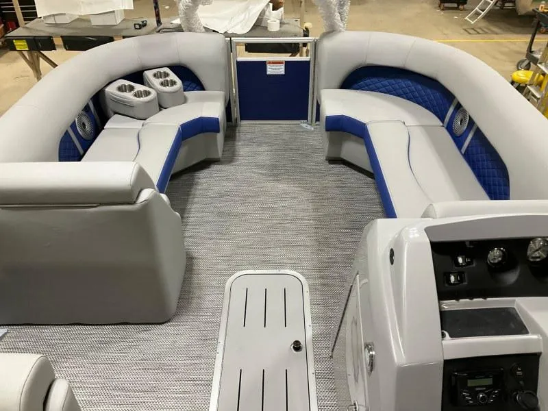 Slide: The Image of 2023 Bennington 21LSB pontoon boat on trailer, parked on gravel. - 2