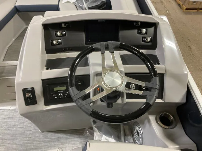 Slide: The Image of 2023 Bennington 23LTSB boat dashboard with steering wheel and control panel. - 10