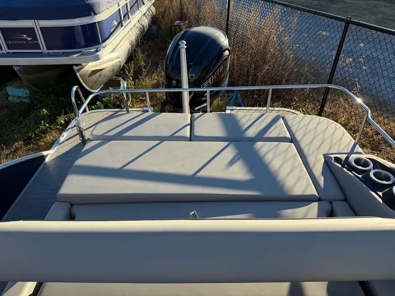 Slide: The Image of 2023 Bennington 23LTSB boat covered on a trailer, parked outdoors. - 14