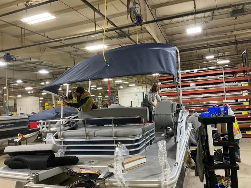 Slide: The Image of 2023 Bennington 23LTSB pontoon boat on trailer under a cloudy sky. - 5