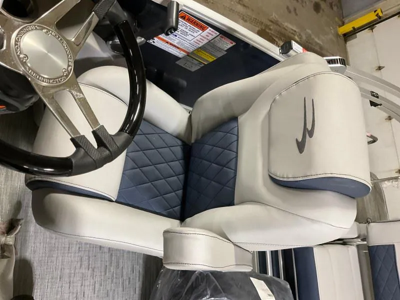 Slide: The Image of 2023 Bennington 23LTSB pontoon boat interior with gray seating and steering console. - 7