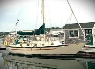 Slide: The Image of 1990 Pacific Seacraft 37 sailboat docked at a marina. - 7