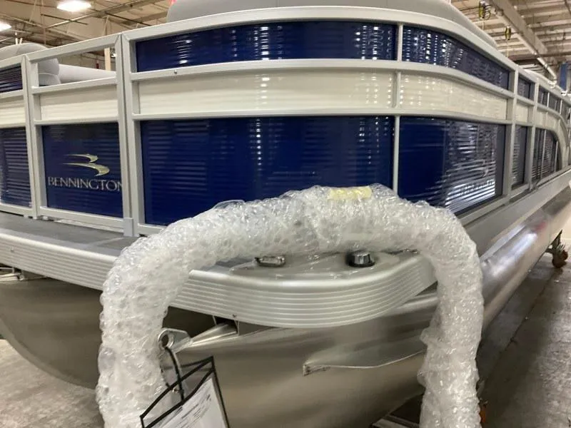 Slide: The Image of 2023 Bennington 208SL pontoon boat on trailer under cloudy sky. - 1