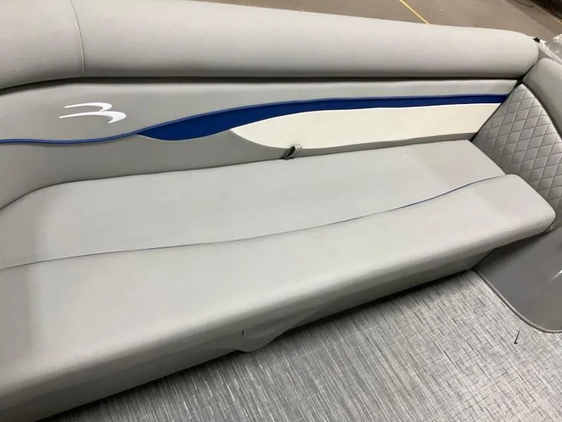 Slide: The Image of 2023 Bennington 208SL pontoon boat on trailer under cloudy sky. - 13