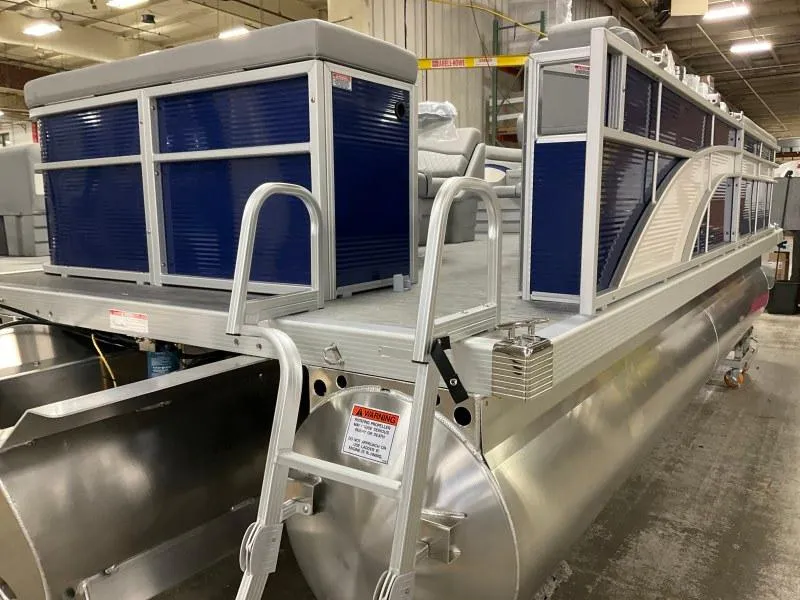 Slide: The Image of 2023 Bennington 208SL pontoon boat with outboard motor, docked under a cloudy sky. - 3