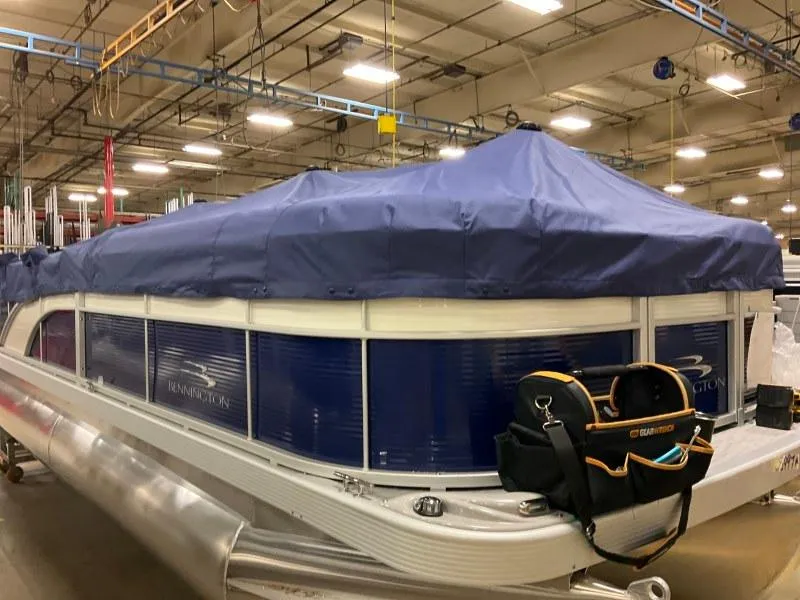 Slide: The Image of 2023 Bennington 208SL pontoon boat interior with steering console and seating. - 5