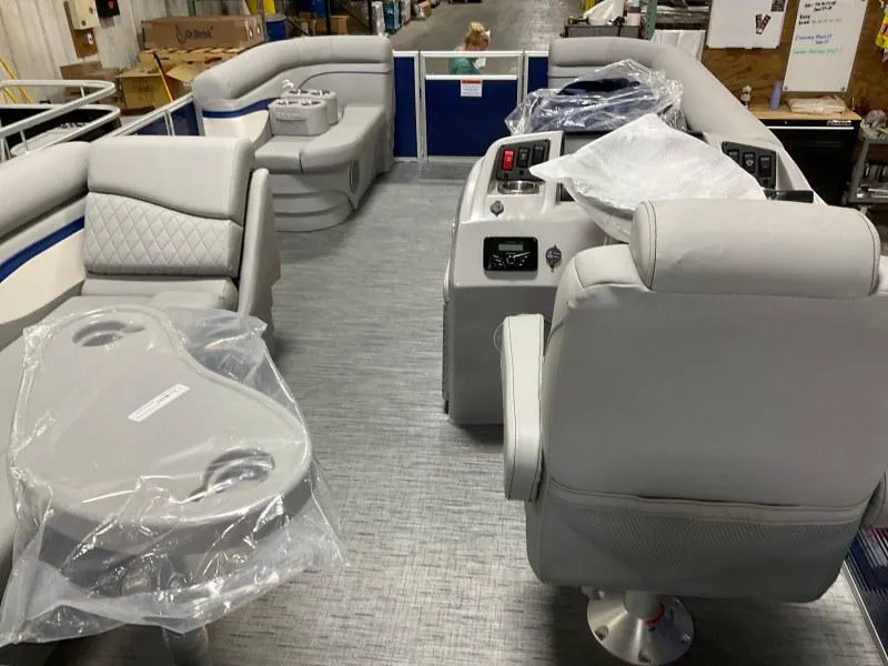 Slide: The Image of 2023 Bennington 208SL pontoon boat with gray seating, docked at a marina. - 9
