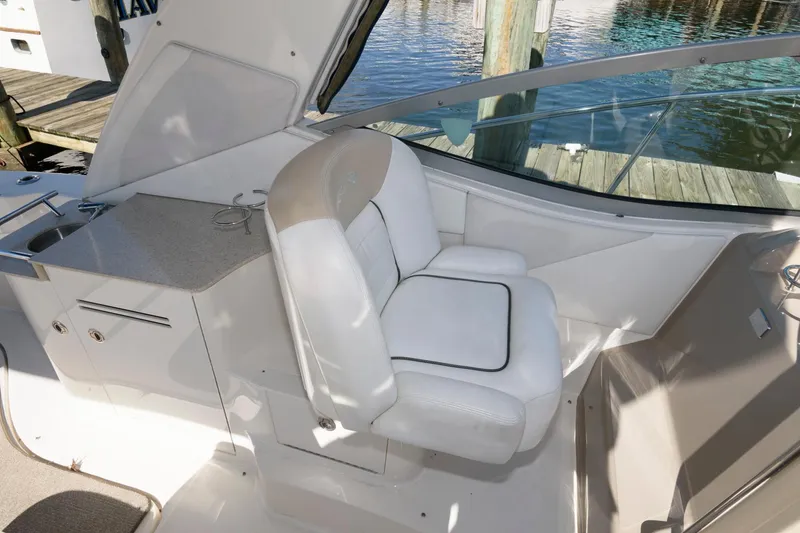 Slide: The Image of 2009 Sea Ray 330 Sundancer cockpit with white seating and waterfront view. - 11