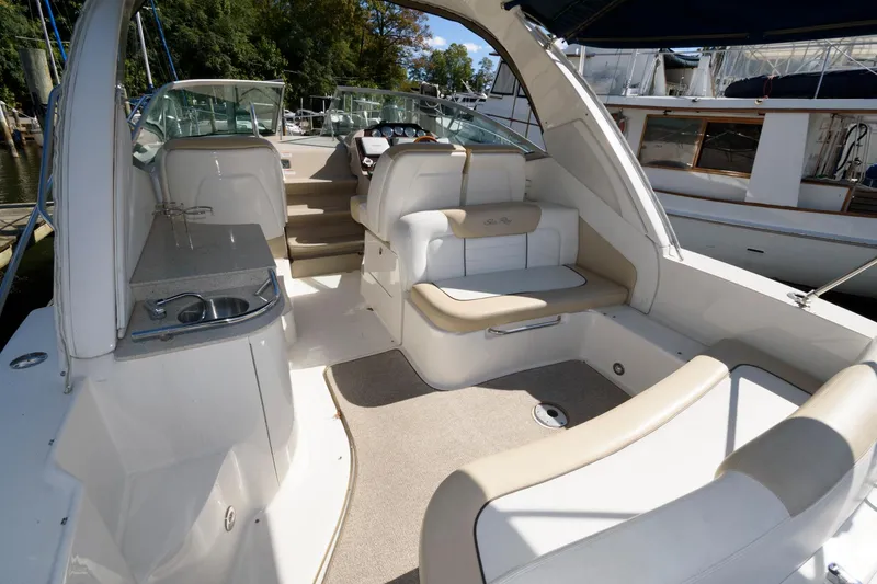 Slide: The Image of 2009 Sea Ray 330 Sundancer boat interior with seating and kitchenette. - 3