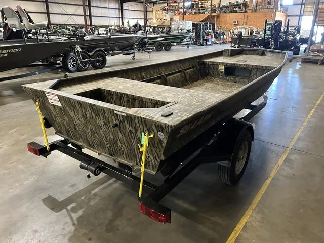 Slide: The Image of 2025 SeaArk 1648 Special boat without motor in warehouse setting. - 4