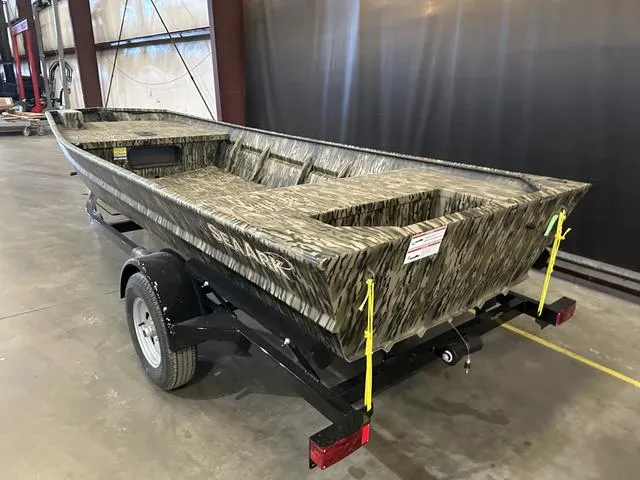 Slide: The Image of 2025 SeaArk 1648 Special boat, camouflage design, on trailer in warehouse. - 5