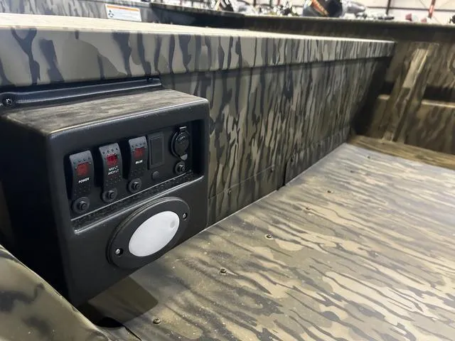 Slide: The Image of 2025 SeaArk 1648 Special boat interior with camo design and control panel. - 9