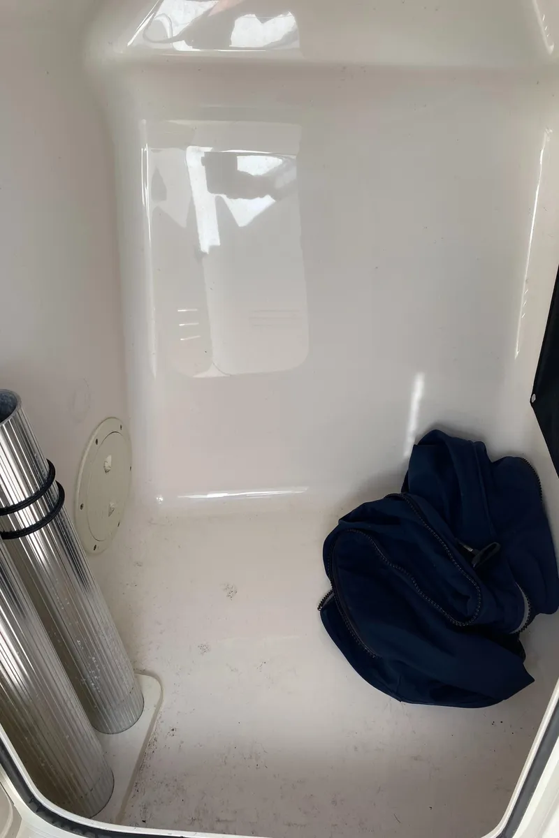 Slide: The Image of Interior storage compartment of 2013 Pursuit DC 235 Dual Console boat. - 10