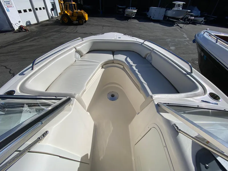 Slide: The Image of 2013 Pursuit DC 235 Dual Console boat with spacious seating and sleek design. - 6