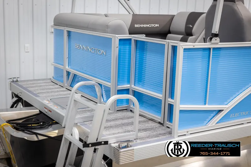 Slide: The Image of 2025 Bennington 16 SFSE pontoon boat with blue panels and ladder in a showroom. - 40