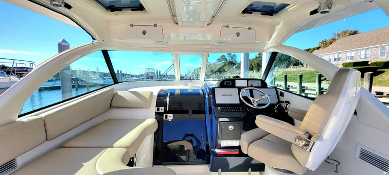 Slide: The Image of Interior of 2015 Pursuit OS 345 Offshore boat with luxurious seating and modern helm. - 10