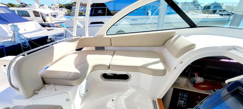 Slide: The Image of 2015 Pursuit OS 345 Offshore boat interior with beige seating and modern design. - 15