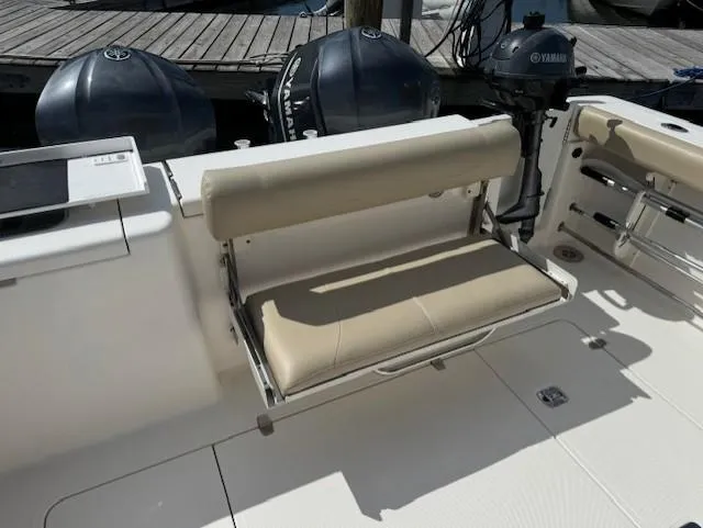 Slide: The Image of 2015 Pursuit OS 345 Offshore boat with beige foldable seat and Yamaha engines. - 6