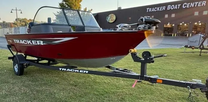 Slide: The Image of 2025 Tracker Pro Guide V-16 WT boat on trailer outside Tracker Boat Center. - 4