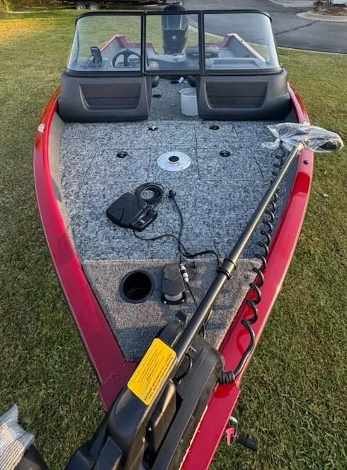Slide: The Image of 2025 Tracker Pro Guide V-16 WT fishing boat with trolling motor on grass. - 6