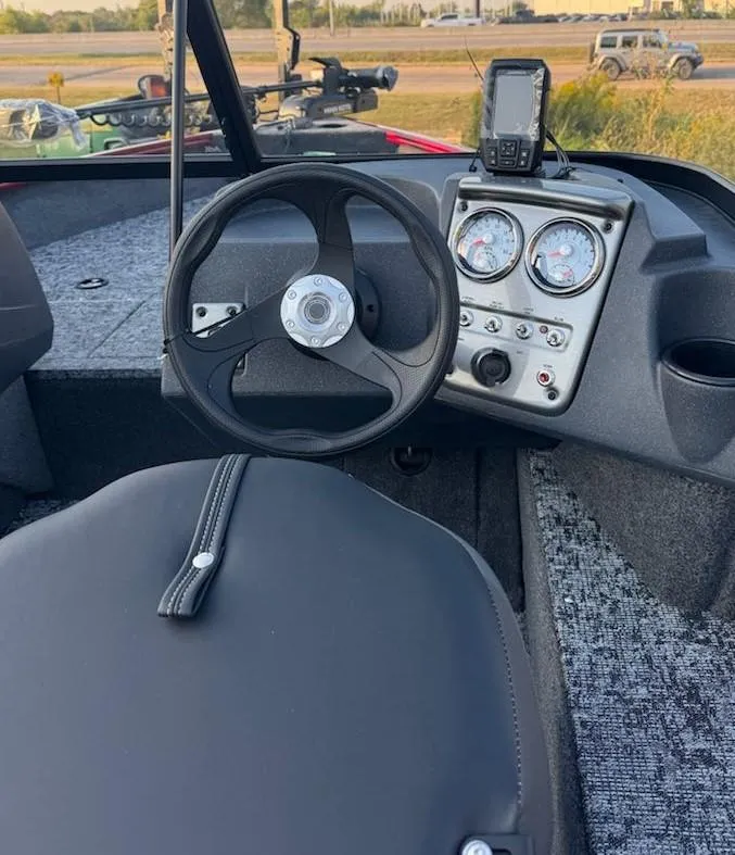 Slide: The Image of 2025 Tracker Pro Guide V-16 WT boat dashboard with steering wheel and gauges. - 7