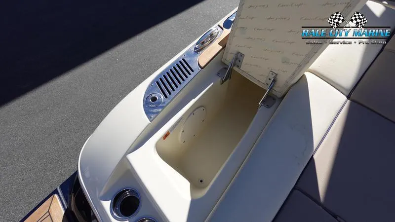 Slide: The Image of 2025 Chris-Craft Sportster boat storage compartment with open lid, showcasing sleek design. - 13