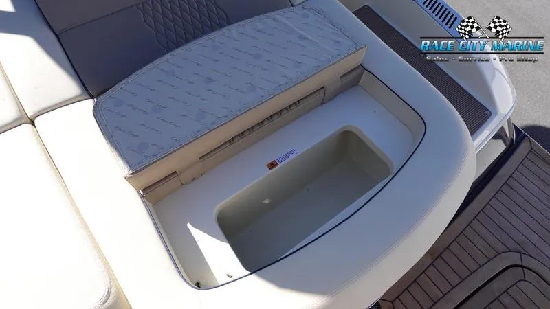 Slide: The Image of 2025 Chris-Craft Sportster boat seat with storage compartment, Race City Marine branding. - 14