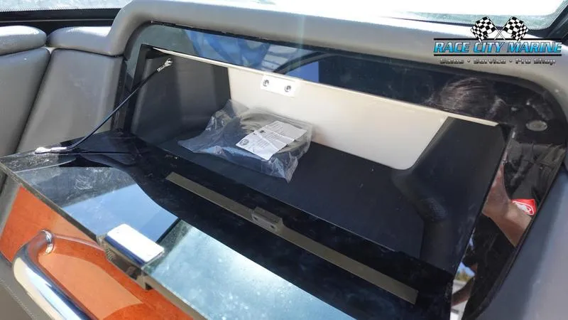 Slide: The Image of 2025 Chris-Craft Sportster dashboard compartment with Race City Marine branding. - 24