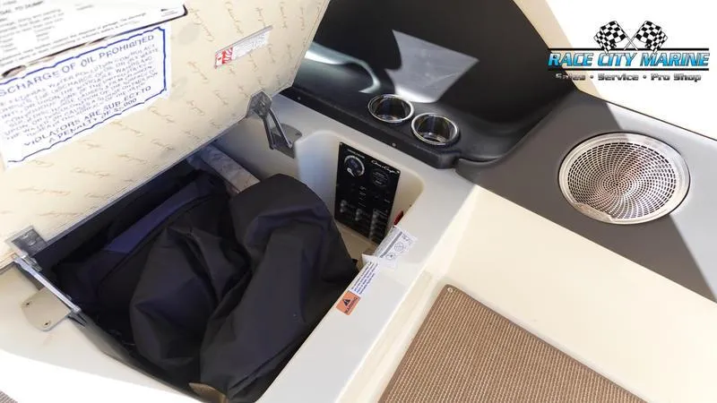 Slide: The Image of 2025 Chris-Craft Sportster interior storage compartment with speaker and cup holders. - 26