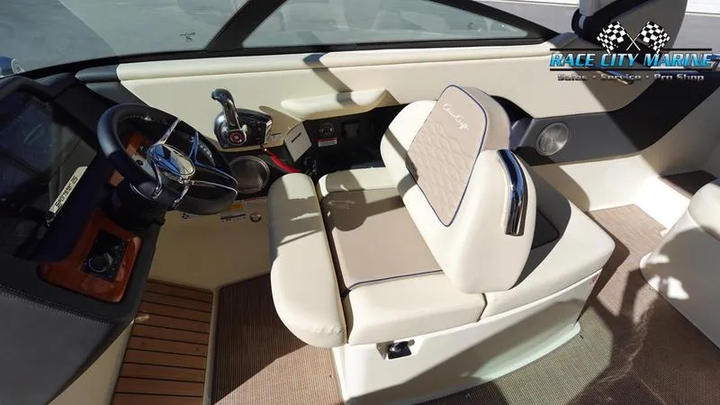 Slide: The Image of 2025 Chris-Craft Sportster interior with beige seating and modern dashboard. - 27
